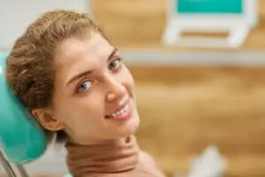 happy woman at dental office sedation concept