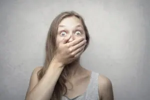Photo by Andrea Piacquadio: https://www.pexels.com/photo/woman-in-gray-tank-top-3812731/ - woman covering her mouth to hide bad breath