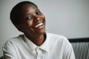 https://www.pexels.com/photo/portrait-of-a-happy-woman-10158002/ Woman smiling wearing a white shirt