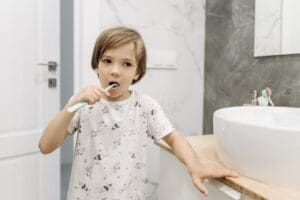 Photo by Pavel Danilyuk: https://www.pexels.com/photo/boy-brushing-his-teeth-8762973/ boy brushing his teeth in a bathroom